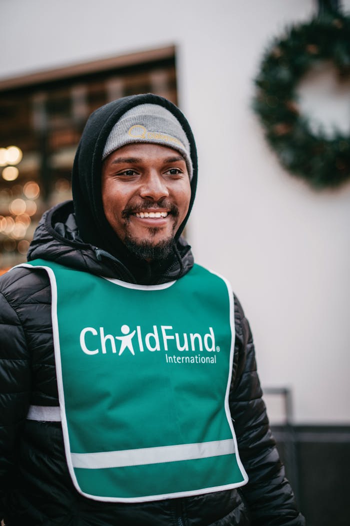 Smiling volunteer for ChildFund International in winter attire, San Luis Obispo.