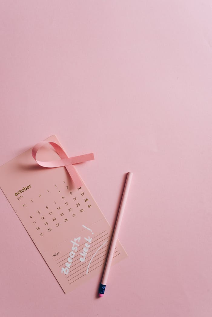 Pink ribbon with calendar promoting breast cancer awareness in October.